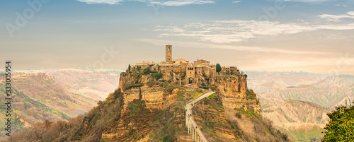 Landscape Civita di Bagnoregio, Viterbo, Lazio, Italy: picturesque landscape at dawn of the ancient village shrouded in fog on the steep tuff hill