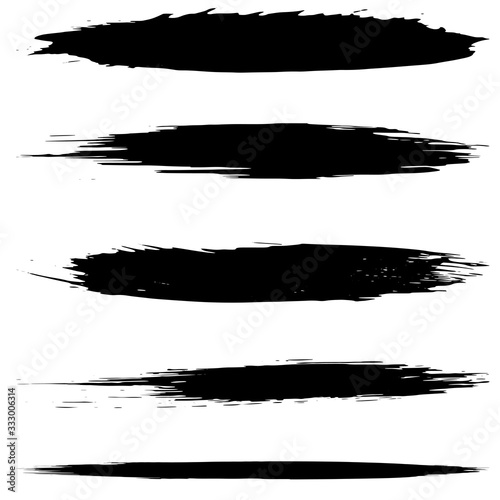 A set of grunge brushes. Abstract strokes of black paint with a dry brush. Blots of ink