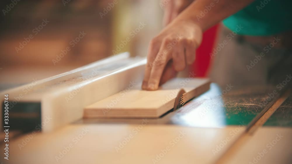 Carpentry working - man cutting out the piece of wood Carpentry working - man cutting out the piece of wood