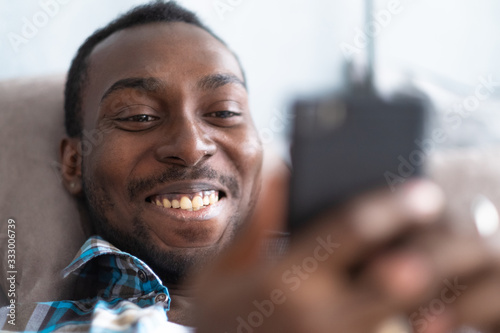black man uses a smartphone to communicate on the Internet.
