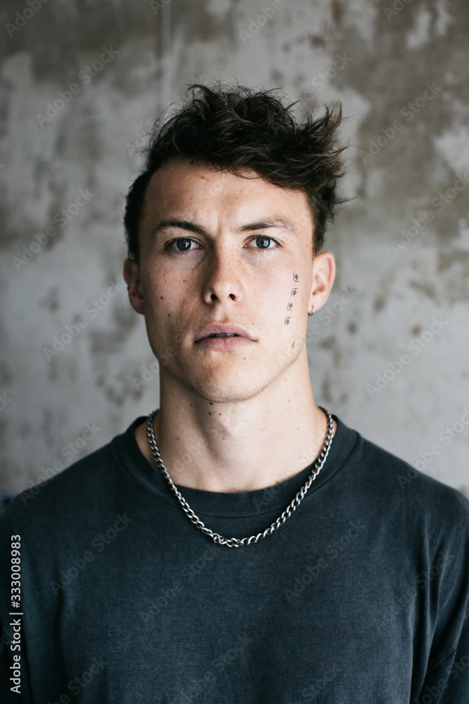 Indoor Portrait of Cool Caucasian Man With Face Tattoo Indoor Portrait of Cool Caucasian Man With Face Tattoo