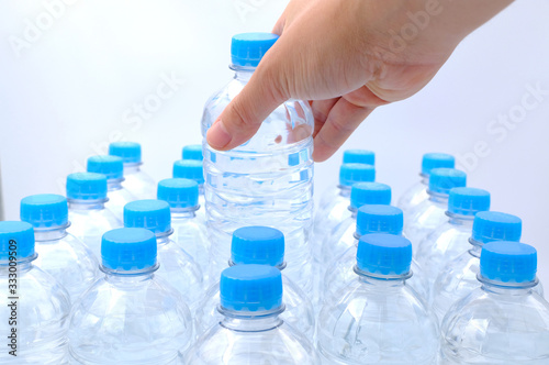 Hand hold one bottle of Pack of Plastic bottle isolated on white background, Top view