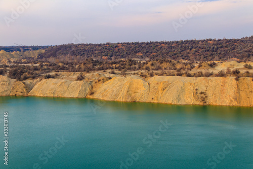 View of a lake with sandy shores in flooded sand quarry