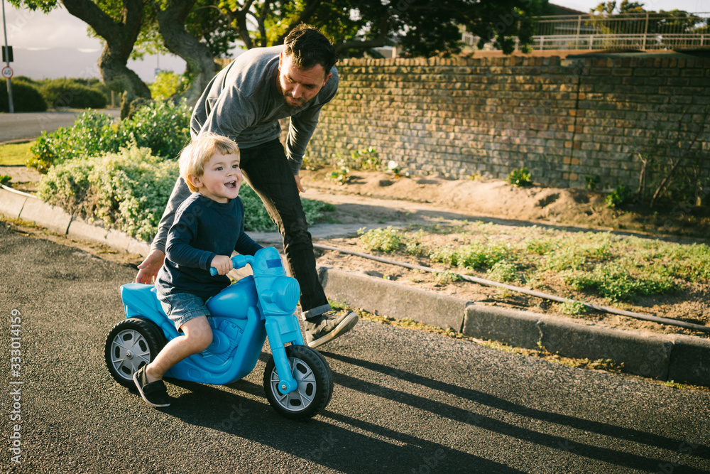 Dad teaching son to ride a bike Dad teaching son to ride a bike