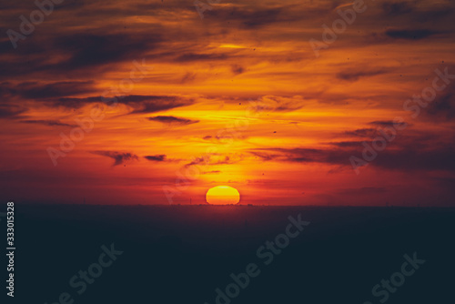 Fototapeta Naklejka Na Ścianę i Meble -  sunset in the sky rounded sun clouds