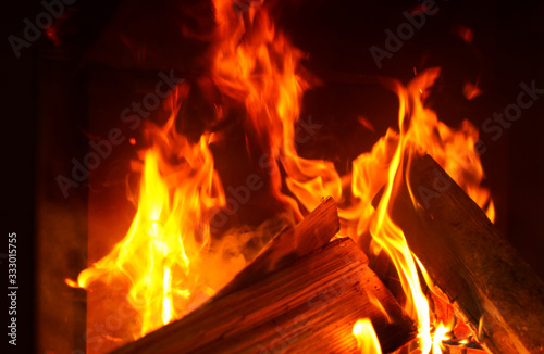 Fireplace with burning wood, closeup view. Winter vacation