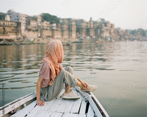 Western woman on a boat exploring the River Ganges