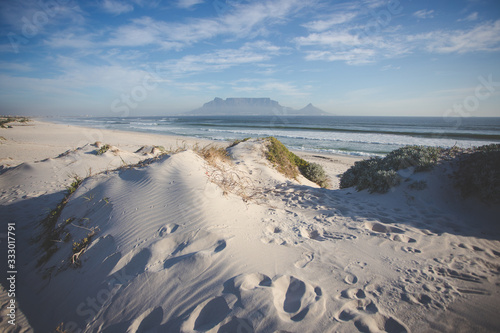 Wide angle view of Table Mountain, one of the natural seven wonders of the world, as seen from Blouberg Beach in Cape Town South Africa