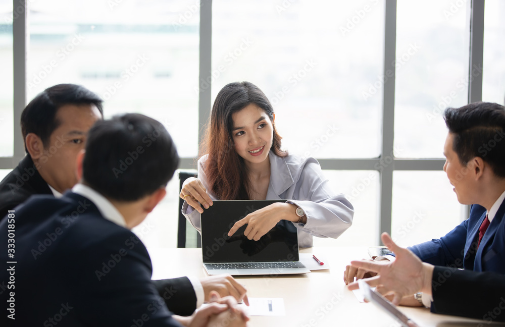 Business woman making a presentation at office. Business executive delivering a presentation to his colleagues during meeting or in-house business training, explaining business plans to his employees. Business woman making a presentation at office. Business executive delivering a presentation to his colleagues during meeting or in-house business training, explaining business plans to his employees.