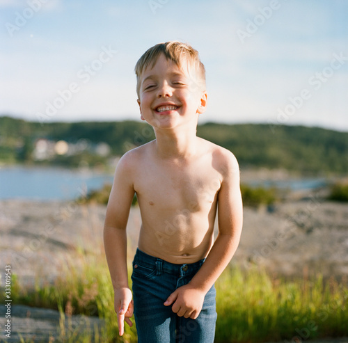 Portrait of a cute boy in jeans and no shirt