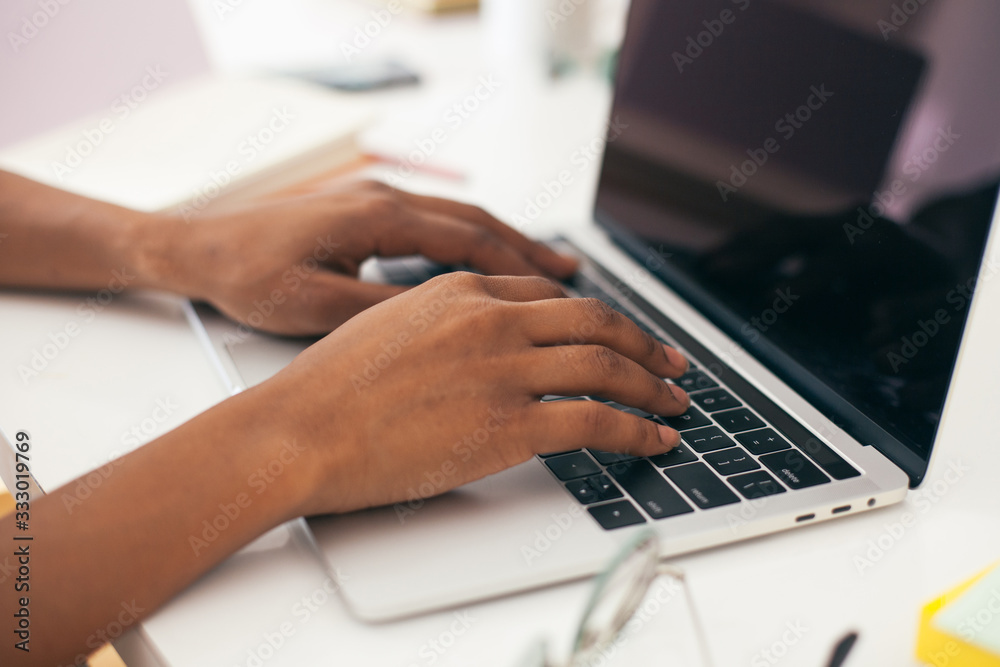 Cool African American woman sitting at her workind desk