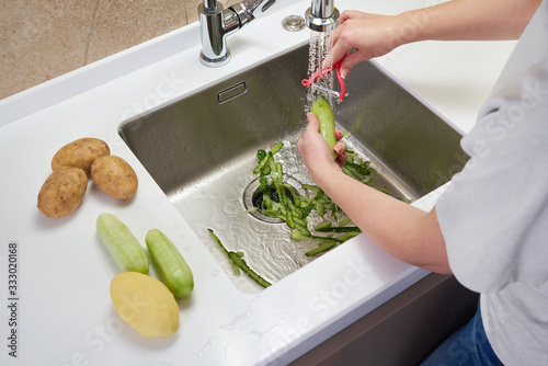 Food waste disposer machine in sink in modern kitchen photo