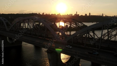  Darnitsky bridge over the Dnieper River. Ukraine city Kiev. Video from the drone. Camera raid on two bridges towards the city at sunset