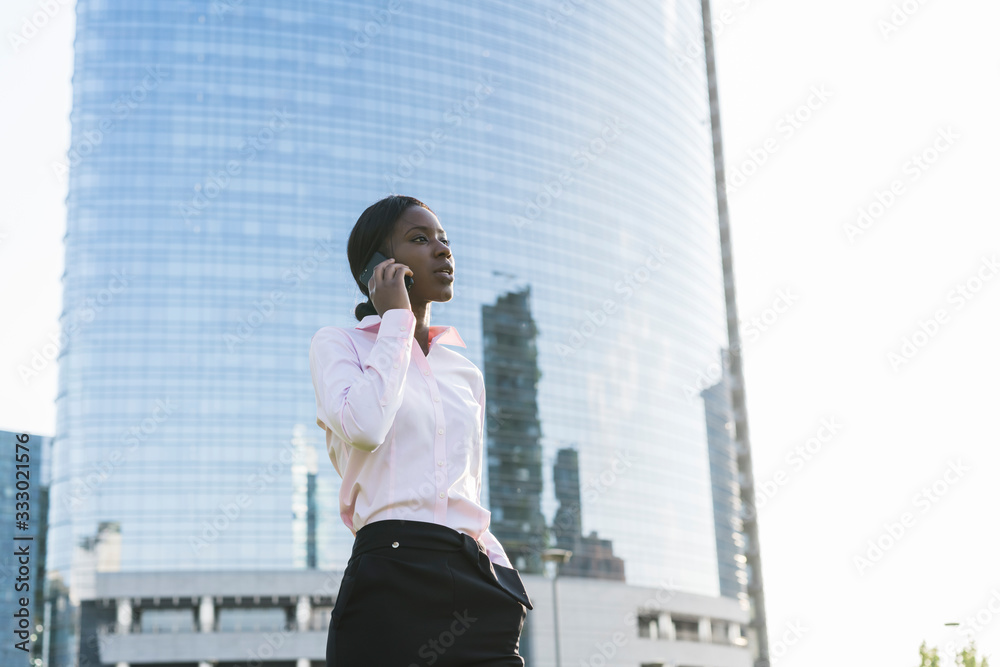 Businesswoman having a call in the city Businesswoman having a call in the city