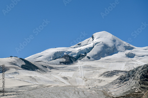View on summer skiing resort under Allalin peak above the Saas-Fee village photo