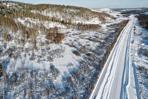 Winter snowy road in Siberia, view from copter © unww