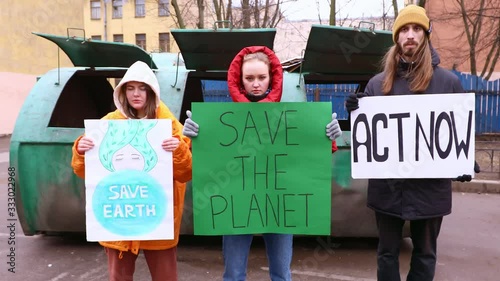 Eco activists with Save the Planet ecology poster.