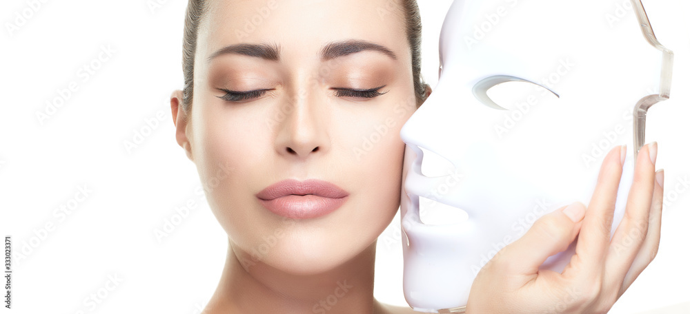Beauty model woman with led mask. Photon therapy light treatment skin rejuvenation led facial mask