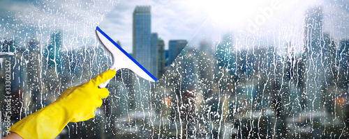 Cleaning window on business building, sky scripper with city background photo