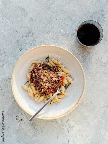 Bowl of vegetarian pasta with wine photo