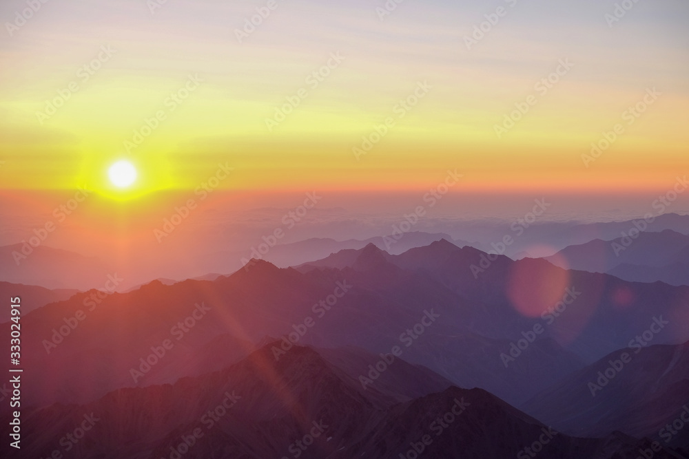 Dawn - sunset in the mountains with sunbeams