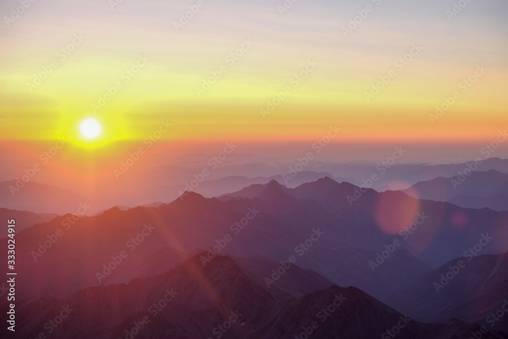 Obraz premium Dawn - sunset in the mountains with sunbeams