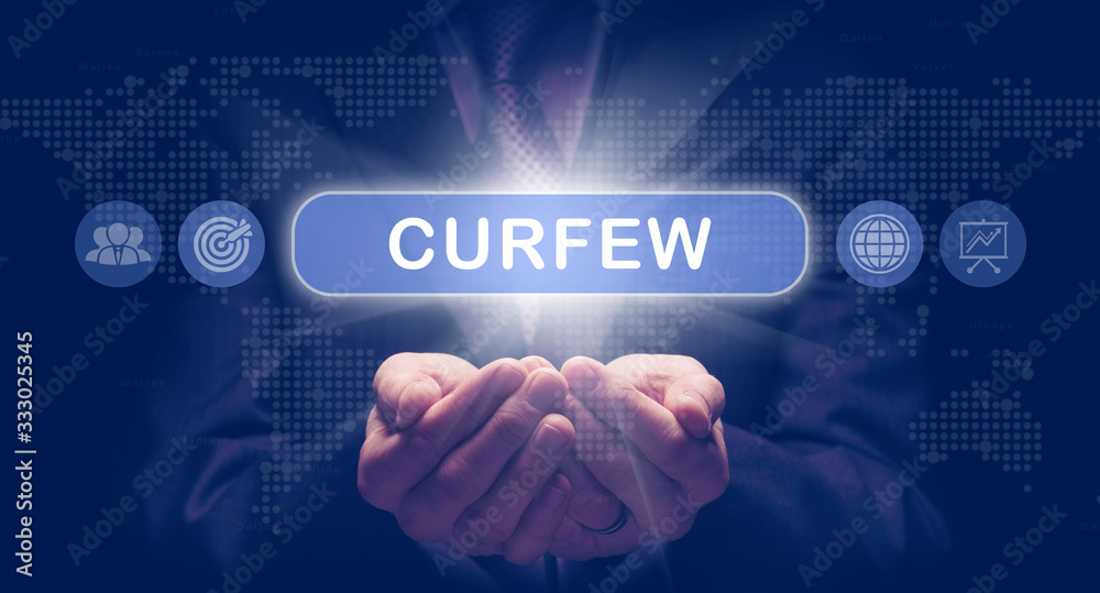 A mans cupped hands holding a virtual display message for the Pandemic Curfew. A mans cupped hands holding a virtual display message for the Pandemic Curfew.