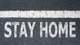 STAY HOME text written on asphalt road