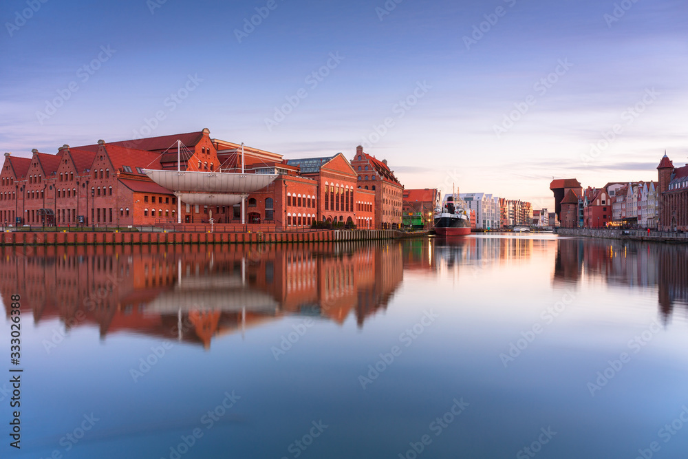 Fototapeta premium Gdansk with beautiful old town over Motlawa river at sunset, Poland.