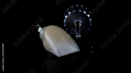 macro photo of a quality dental ceramic crown with a screwdriver