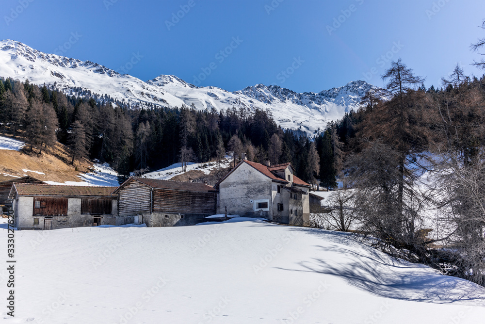 A lonely old farm on the empty and deserted ski slopes during the corona virus lockdown in the Swiss Alps