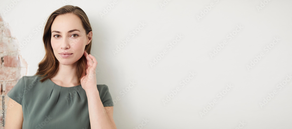 Portrait of thoughtful pretty businesswoman looking into the camera with copy space Portrait of thoughtful pretty businesswoman looking into the camera with copy space