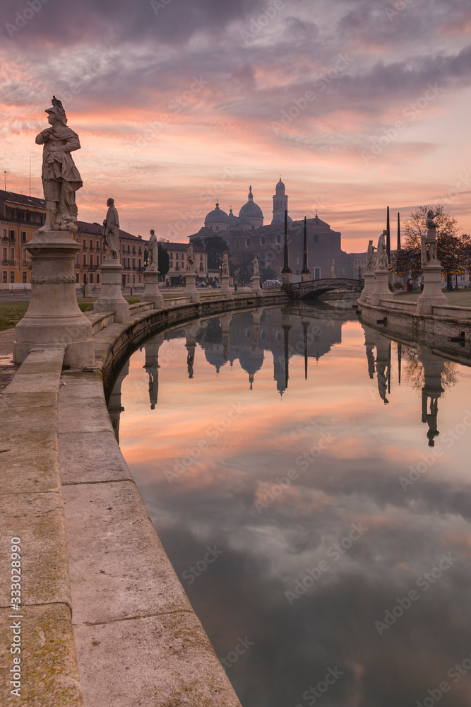 The magnificent statues of the Prato della Valle square during sunrise, Padova, Italy.