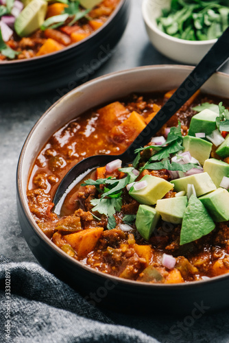 Paleo chili con carne closeup with fresh avocado photo