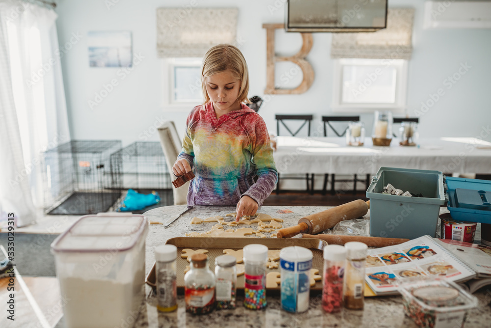 Young girl baking sugar cookies in kitchen Young girl baking sugar cookies in kitchen