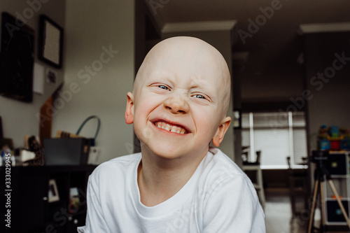 Headshot of boy smiling at camera in living room of house photo