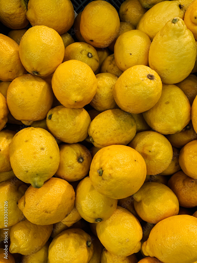 lots of delicious ripe yellow sour lemons to eat a background