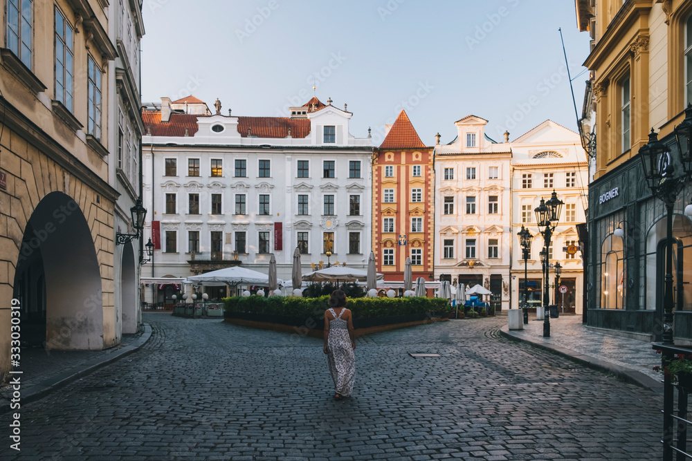 Woman walking through Old Town streets in Prague, Czech Republic