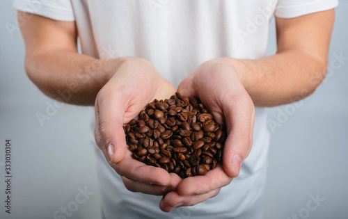 Man holding coffee and enjoys the aroma close up