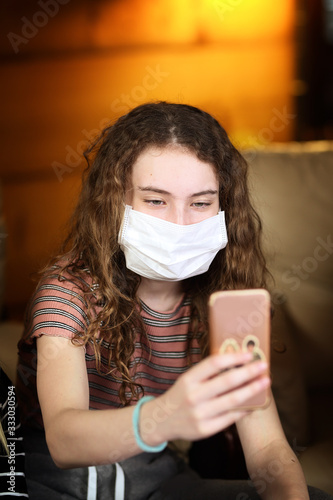young girl taking a selfie with a mask