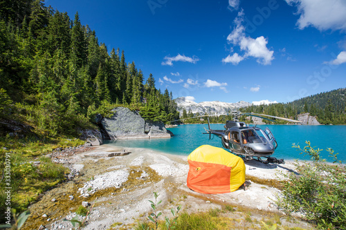 Helicopter passengers evacuate and test out emergency shelter on beach photo