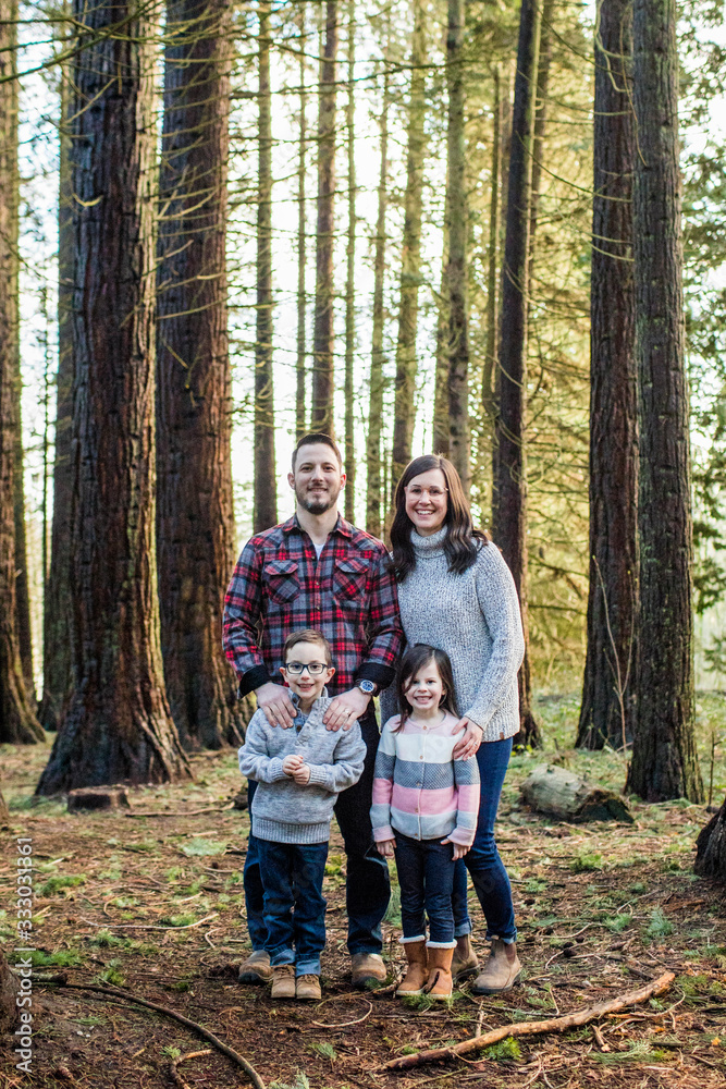 portrait of attractive family standing in the forest. portrait of attractive family standing in the forest.