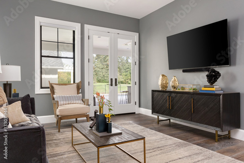 Beautiful living room in new luxury home with French doors and big tv