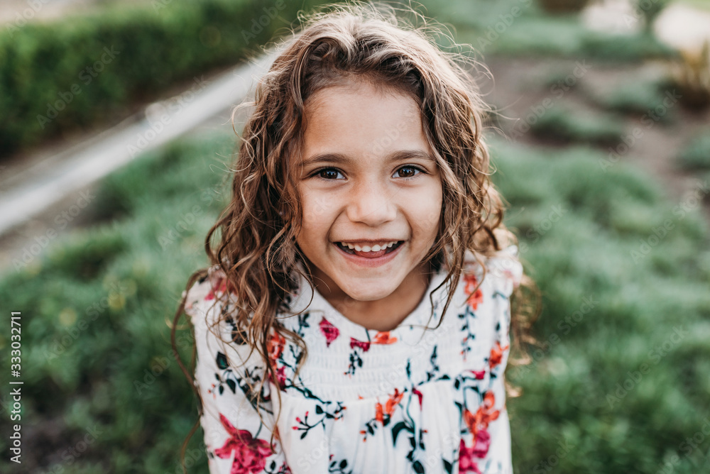 Close up portrait of young school-aged happy girl smiling at Close up portrait of young school-aged happy girl smiling at