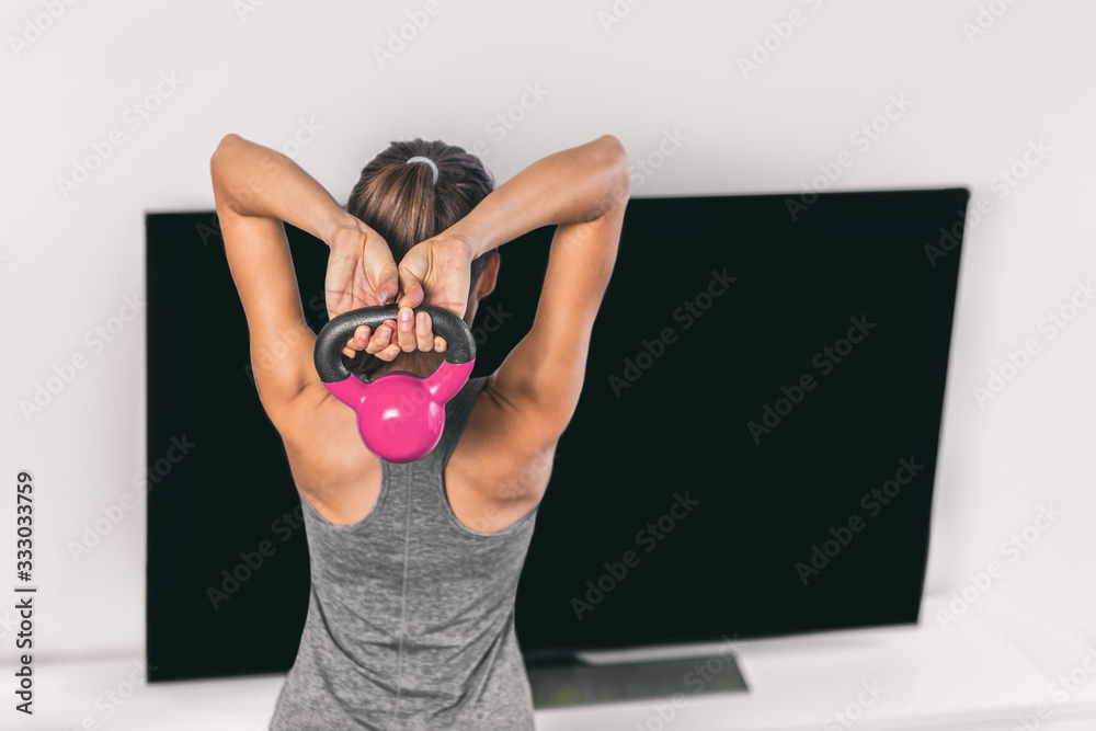 Φωτογραφία Home strength training workout overhead triceps extension muscles exercises woman watching online tv class live streaming at home