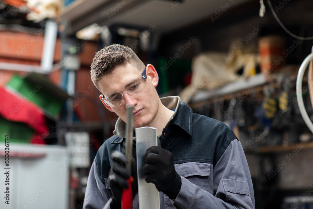 Plumber male working in a workshop Plumber male working in a workshop