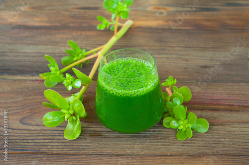 Green herb smoothie on  wooden brown table