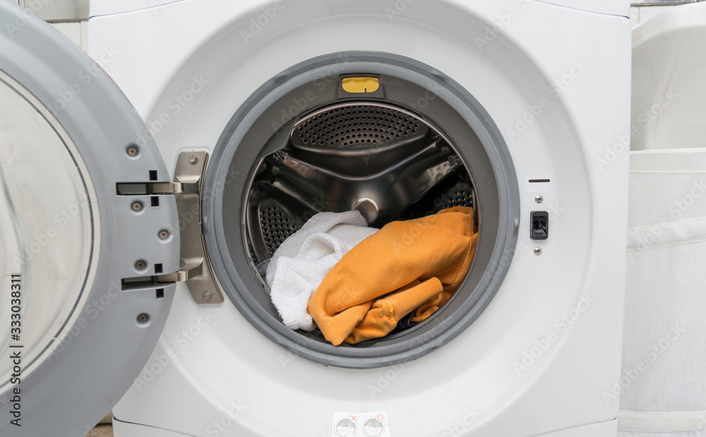 Close up view of a washing machine full of clothes Close up view of a washing machine full of clothes