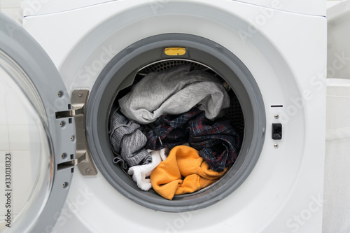 Close up of a washing machine full of clothes