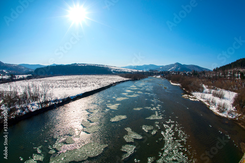 Spring of nature. Melting ice on rivers and ponds. Sunny day by the lake. Beautiful spring landscape